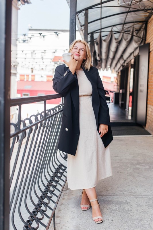 beautiful-young-woman-dress-jacket-walks-around-city-drinks-coffee-min