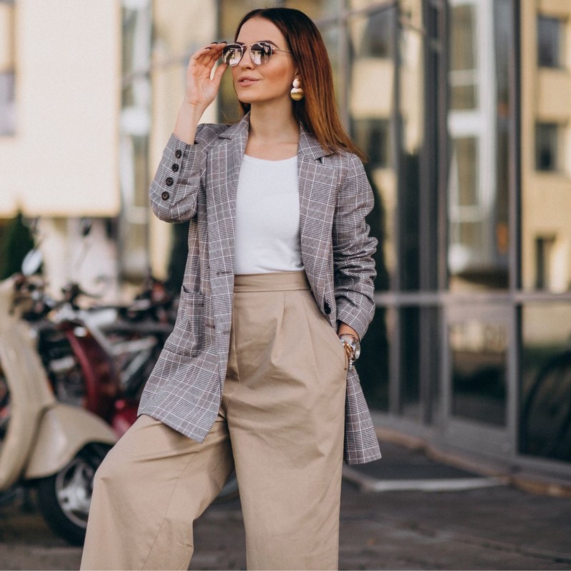 young-woman-suit-standing-by-scooter